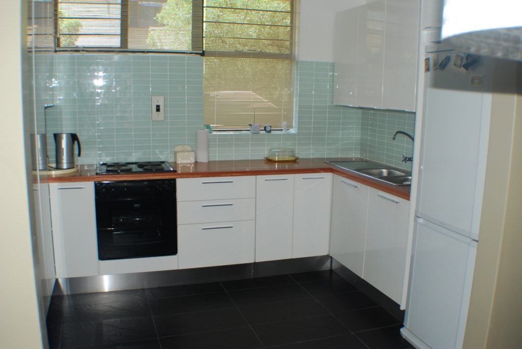 HiGloss white sprayed doors with solid Saligne worktop