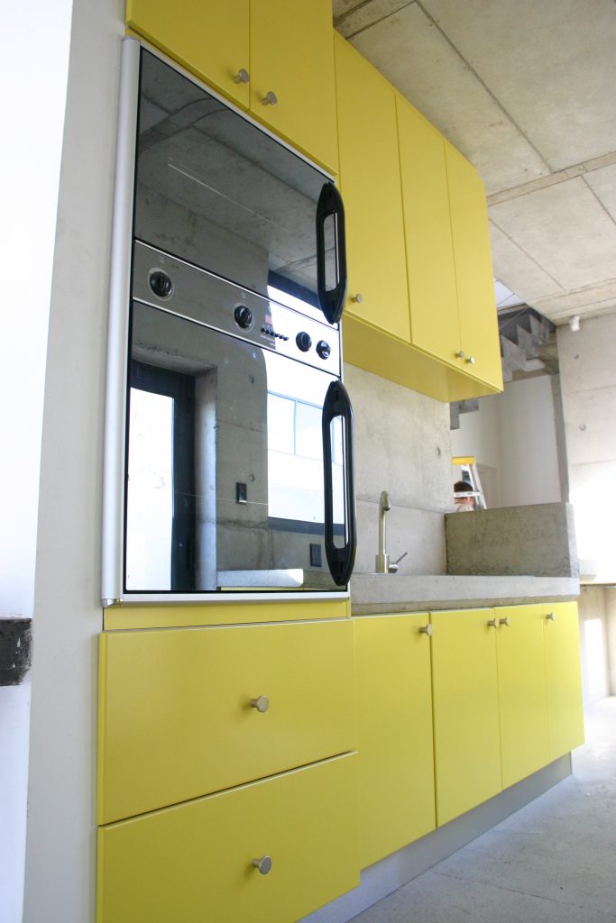 Sprayed yellow doors with concrete counter