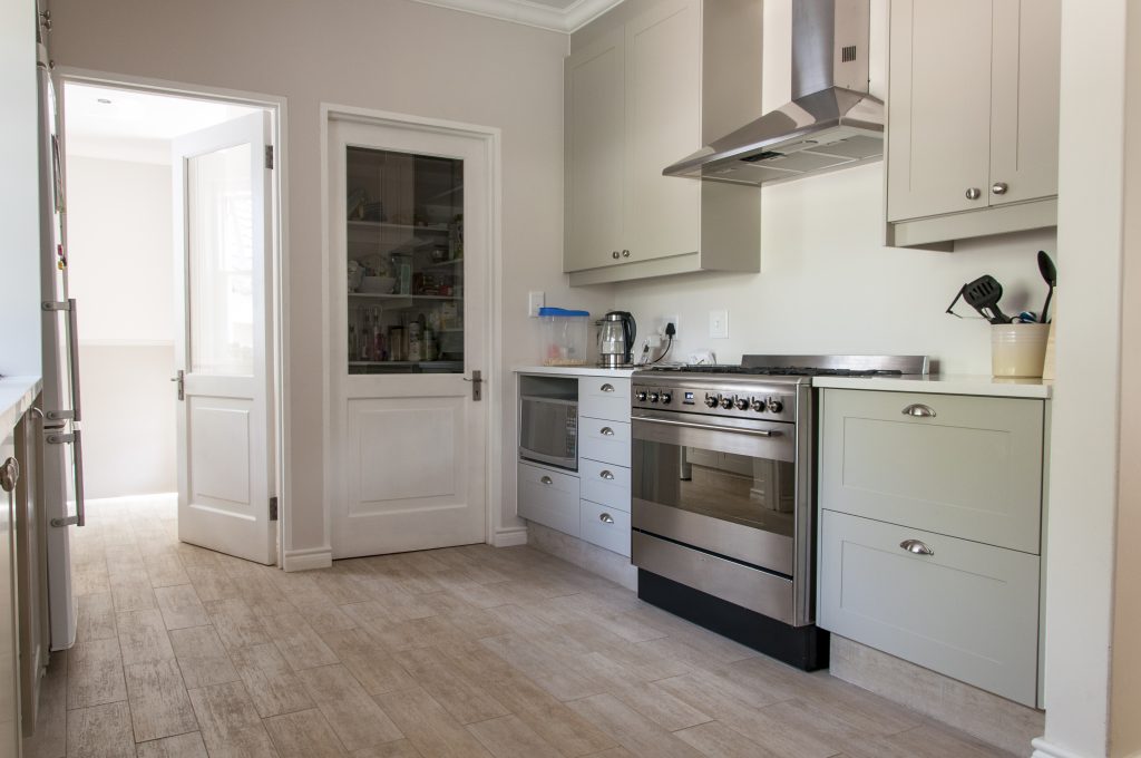 Light grey sprayed shaker doors with solid Saligna worktops