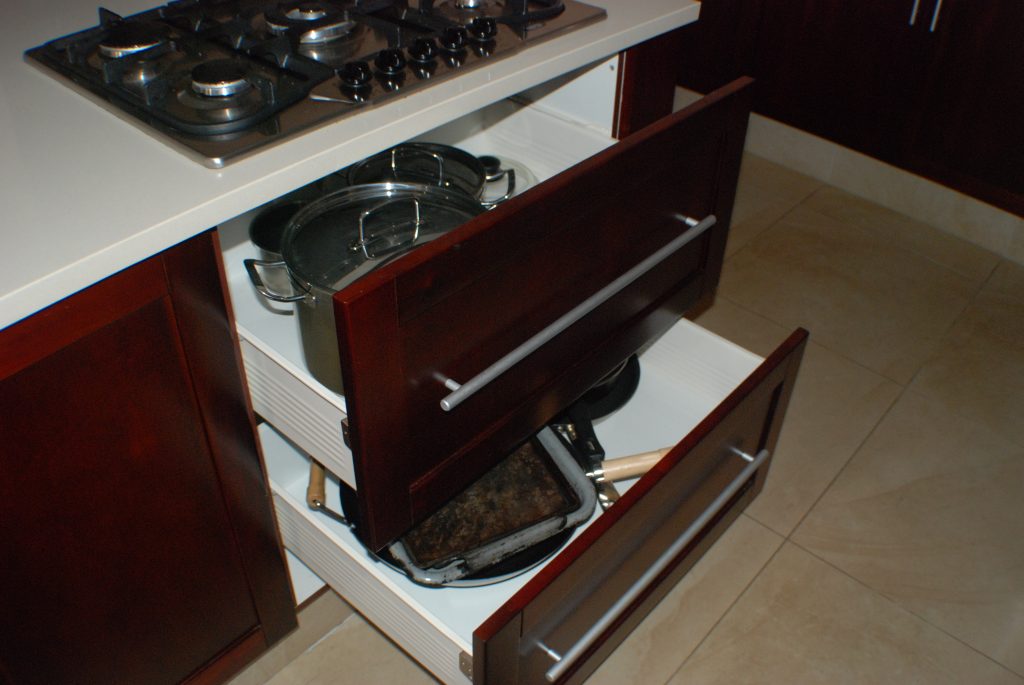 Solid stained mahogany shaker with frosted glass and Sorbet worktops