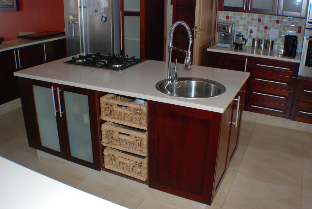 Solid stained mahogany shaker with frosted glass and Sorbet worktops