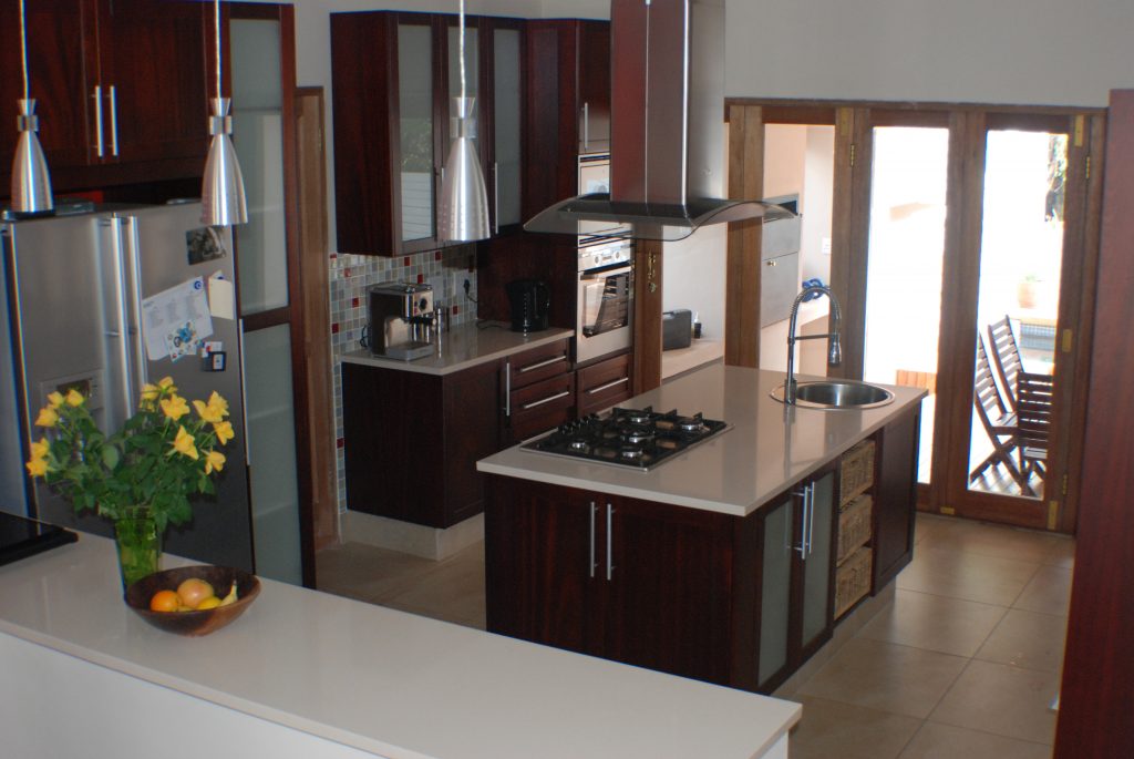 Solid stained mahogany shaker with frosted glass and Sorbet worktops