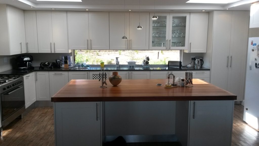 White sprayed shaker doors with Rustenberg granite and solid Saligna work tops