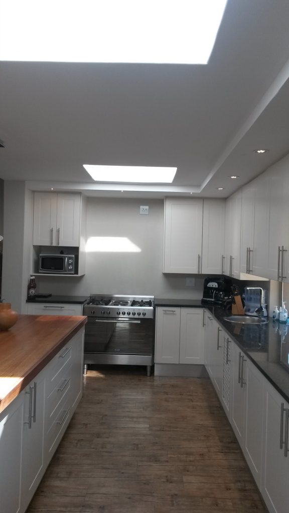 White sprayed shaker doors with Rustenberg granite and solid Saligna work tops