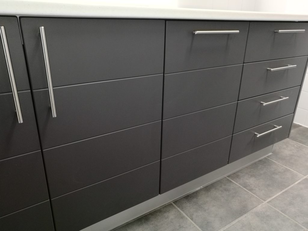 Charcoal wrap with horizontal groove and 'White Myriad' Formica top