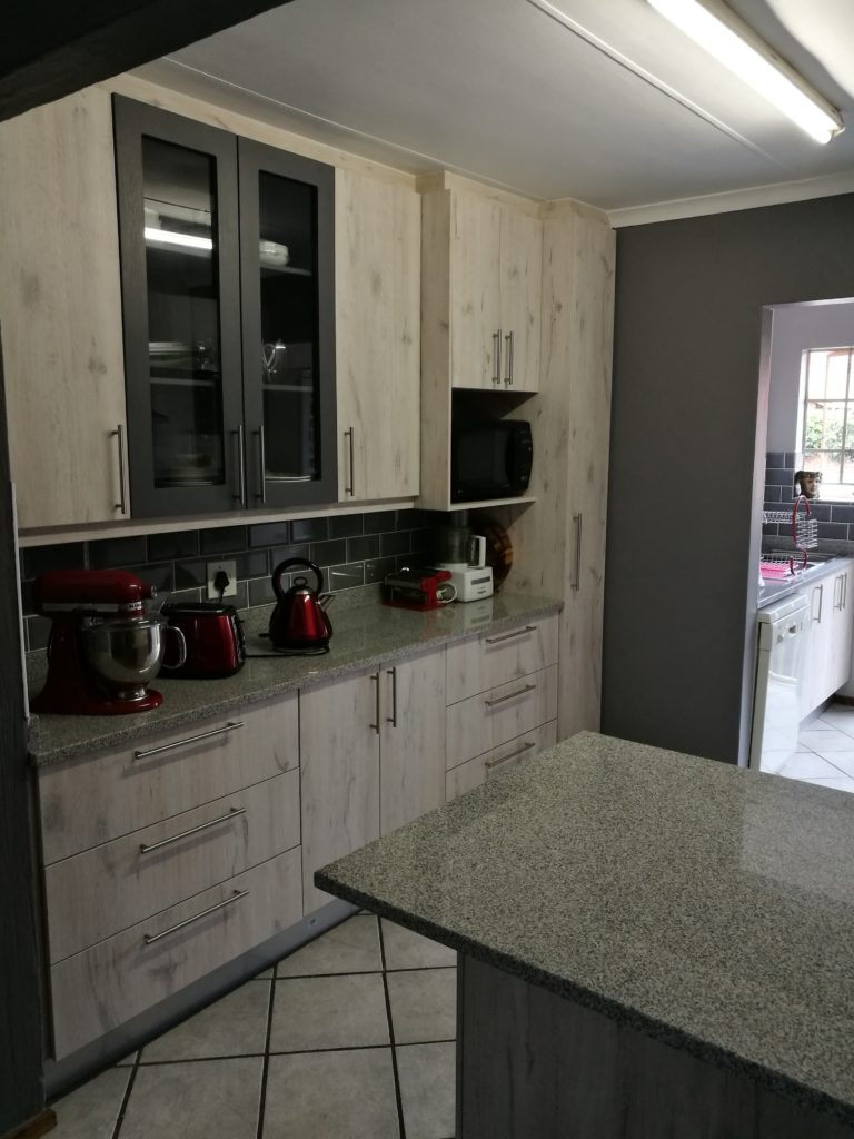 'Nordic Ice' and 'Storm Grey' Impact doors with 'Silver Sardo' Granite